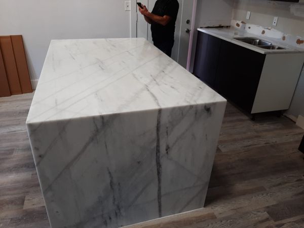 Marble waterfall island fabricated for a modern kitchen